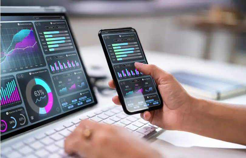 a computer screen and mobile device showing different charts to track changes